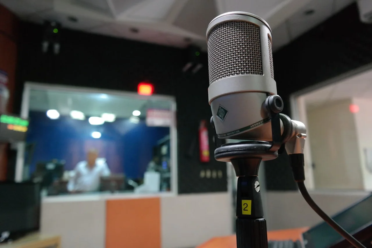 Close-up of condenser microphone with studio background in soft focus