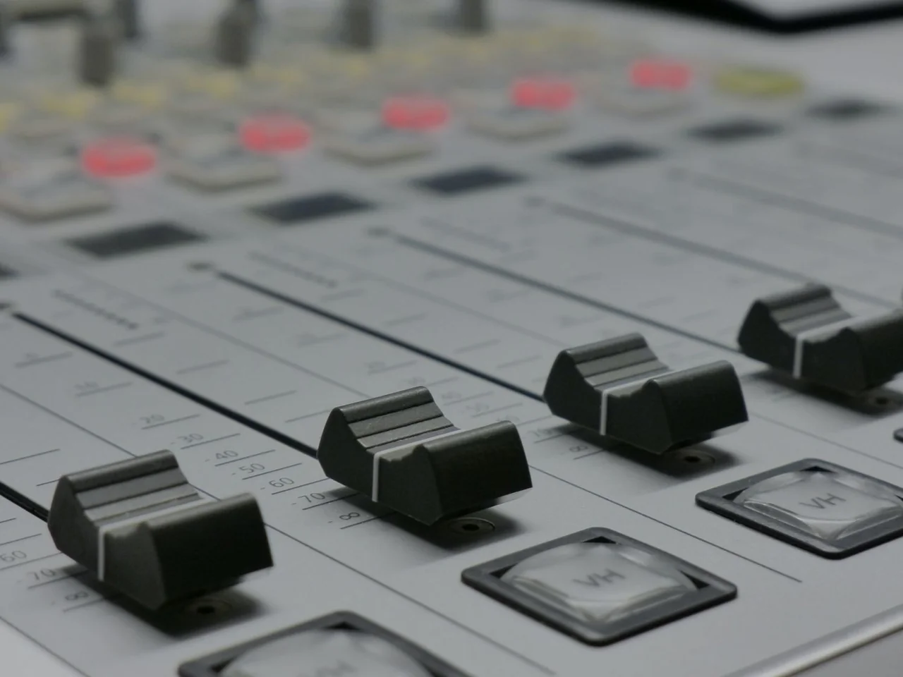 Detailed fader bank showing precise calibration markings on studio console
