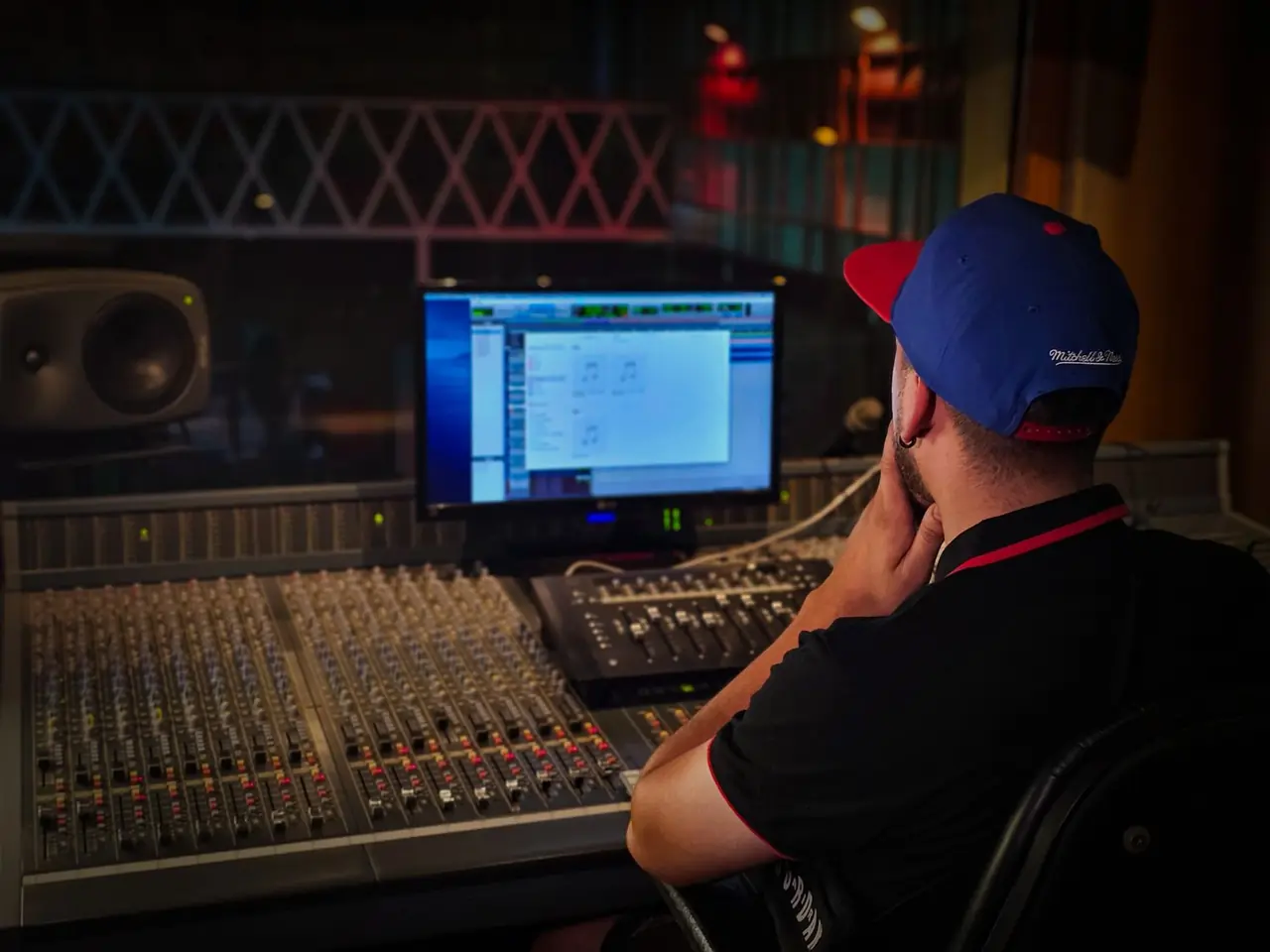Audio production desk with nearfield studio monitors and control faders