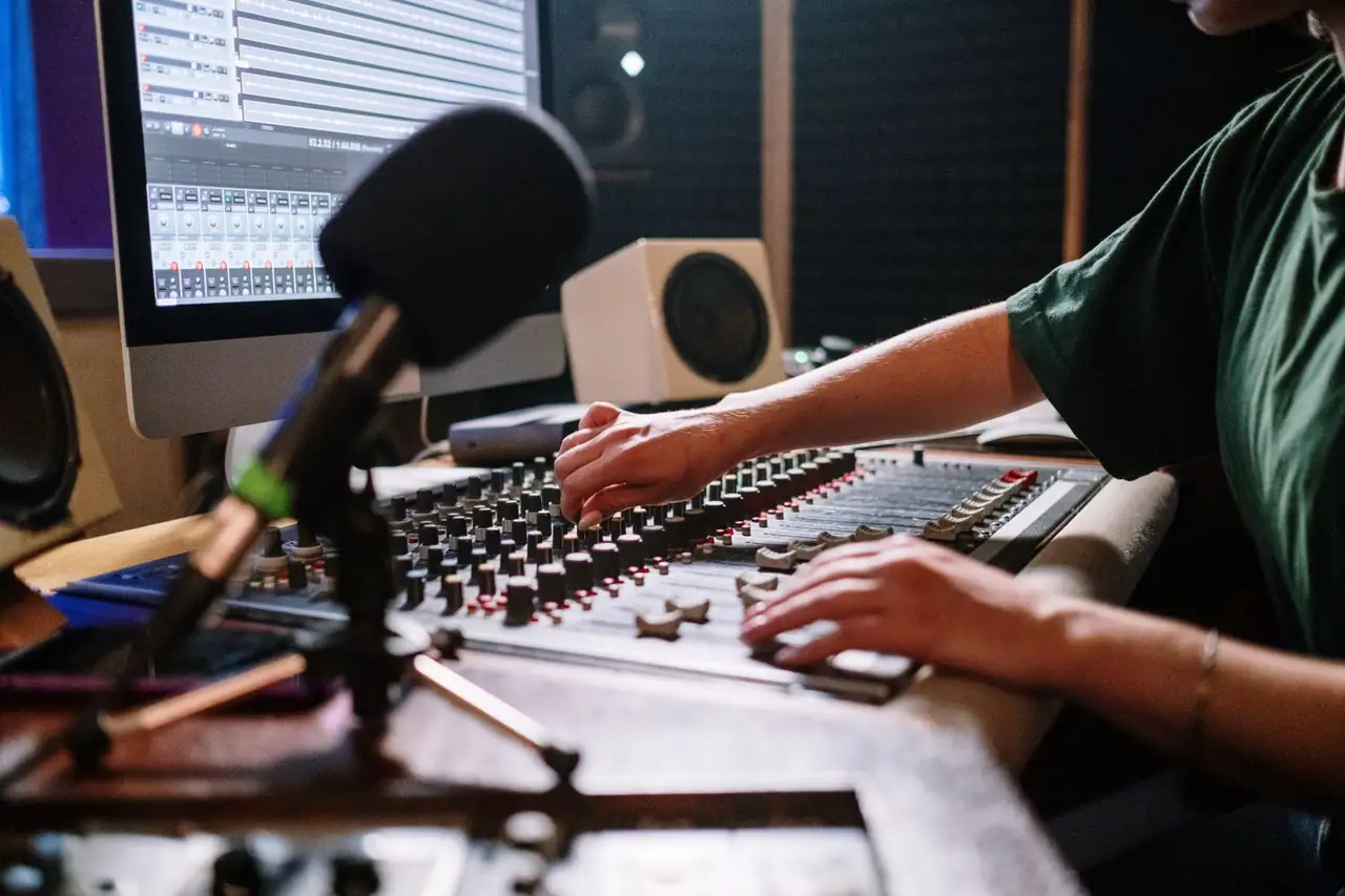 Audio engineer carefully calibrating a mixing console inside Lumariqe Nessora