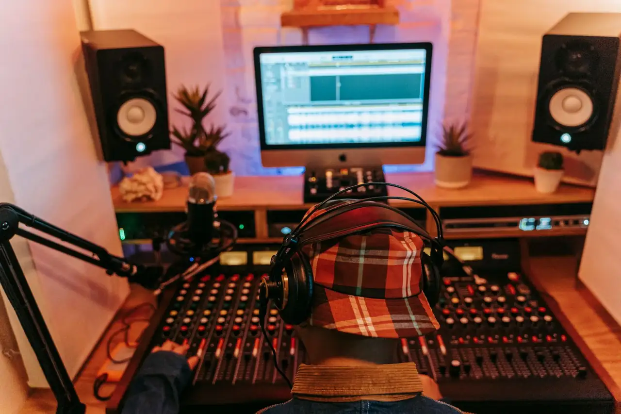 Audio engineer in focused creative session fine-tuning console controls